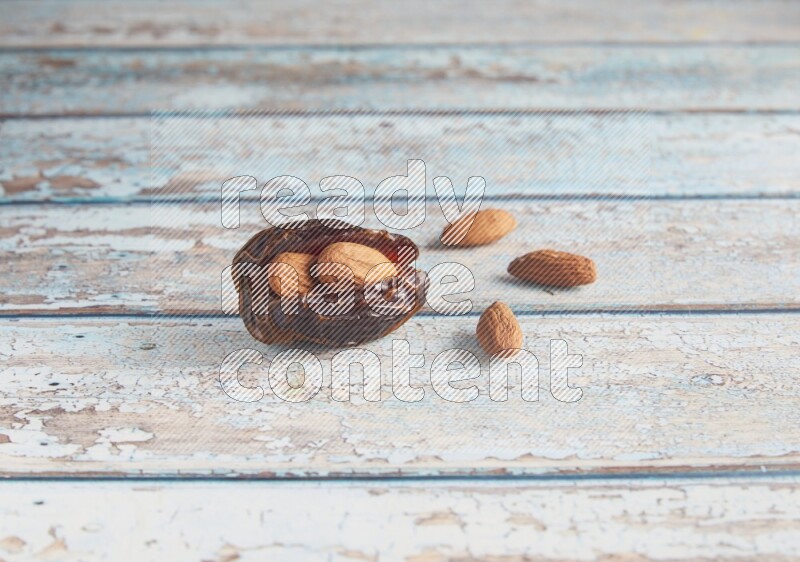 almond stuffed madjoul date on a light blue wooden background