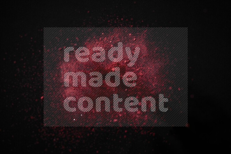 Red powder explosion on black background