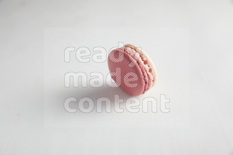 45º Shot of Pink Litchi Raspberry macaron on white background