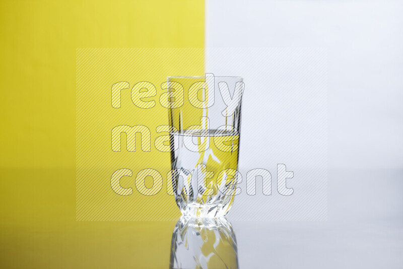 The image features a clear glassware filled with water, set against white and yellow background