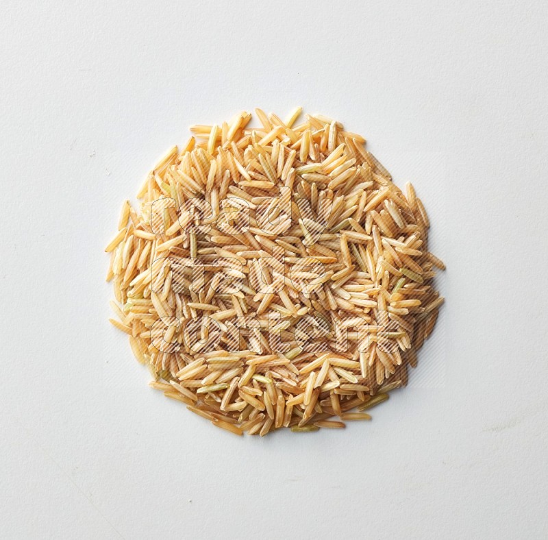 Top-view shot of long grain brown rice on white background