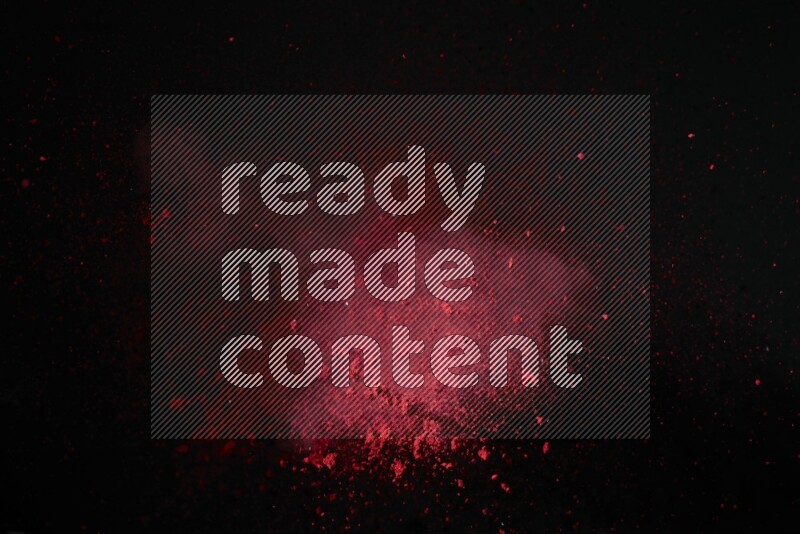 Red powder explosion on black background