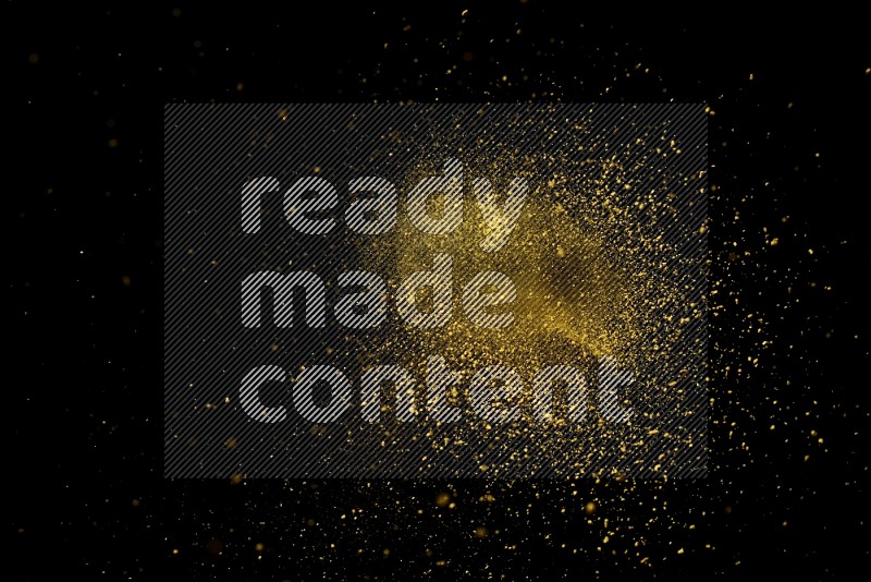Yellow powder explosion on black background