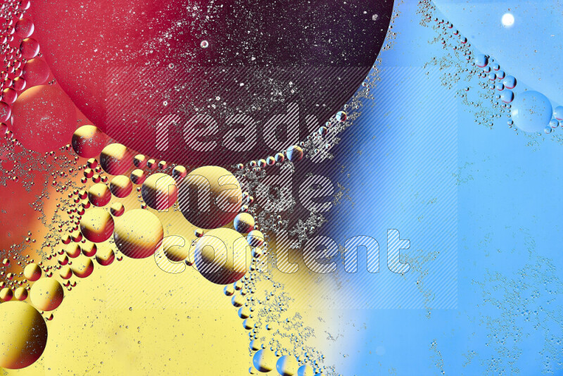 Close-ups of abstract oil bubbles on water surface in shades of yellow, red and blue