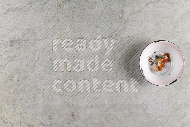 Top View Shot Of A Vintage Metal Plate On Grey Marble Flooring