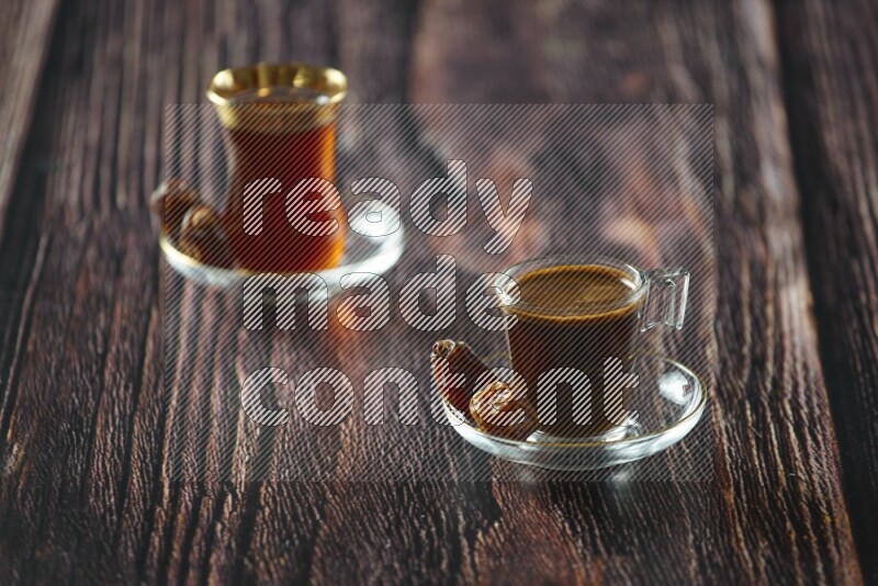 A coffee glass cup with dates and tea on wooden background