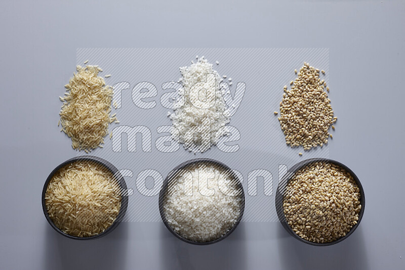 Legumes in pottery bowls on light grey background