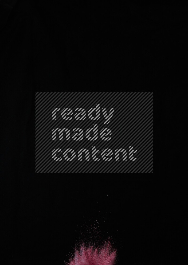 A side view of red powder explosion on black background