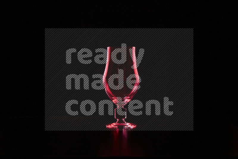 Glassware with rim light in red against black background