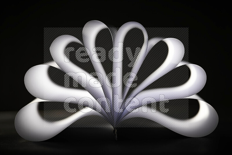 An abstract art piece displaying smooth curves in grey gradients created by colored light