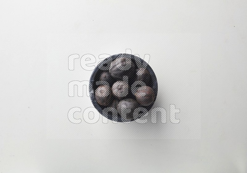 Top-view shot of dried lime (loomi) in a container on white background