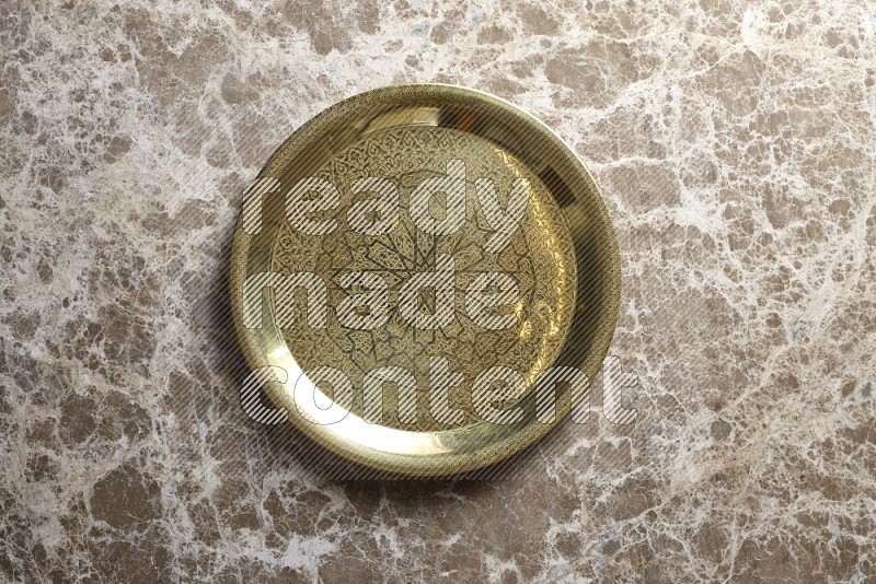 A metal tray on beige marble background