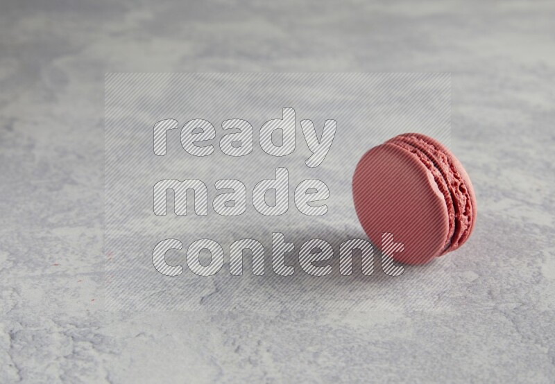 45º Shot of Pink Raspberry macaron on white  marble background