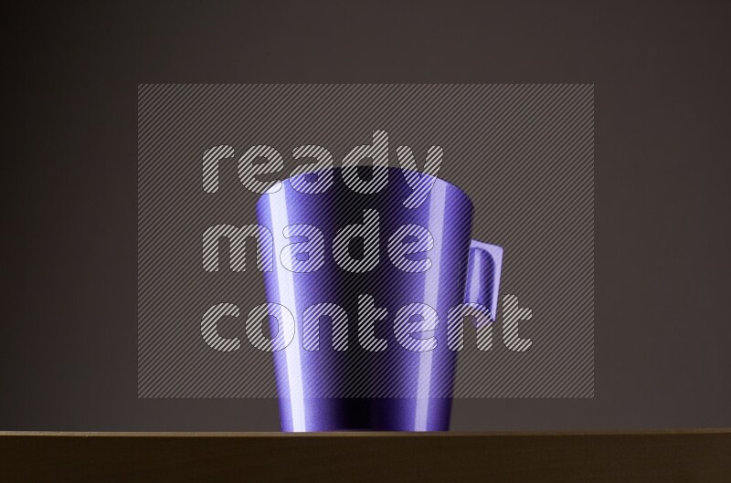 Low angle shot of a purple cup on grey background