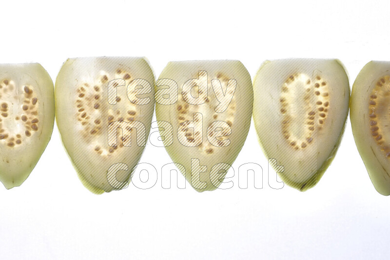Guava slices on illuminated white background