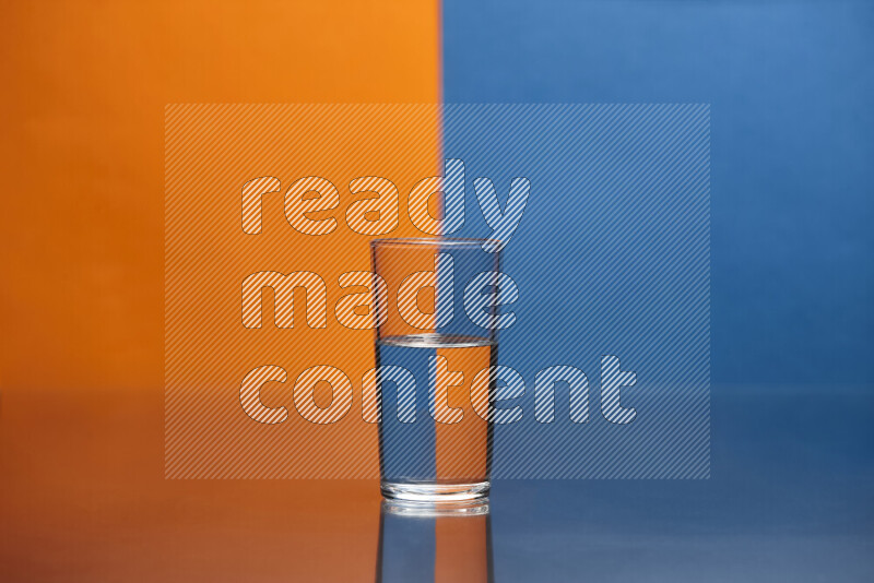 The image features a clear glassware filled with water, set against orange and blue background
