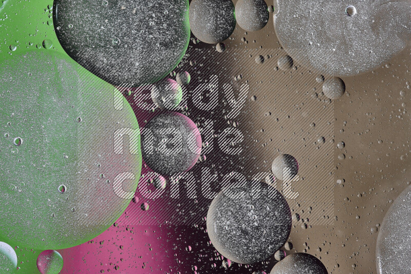 Close-ups of abstract oil bubbles on water surface in shades of brown, black, green and pink