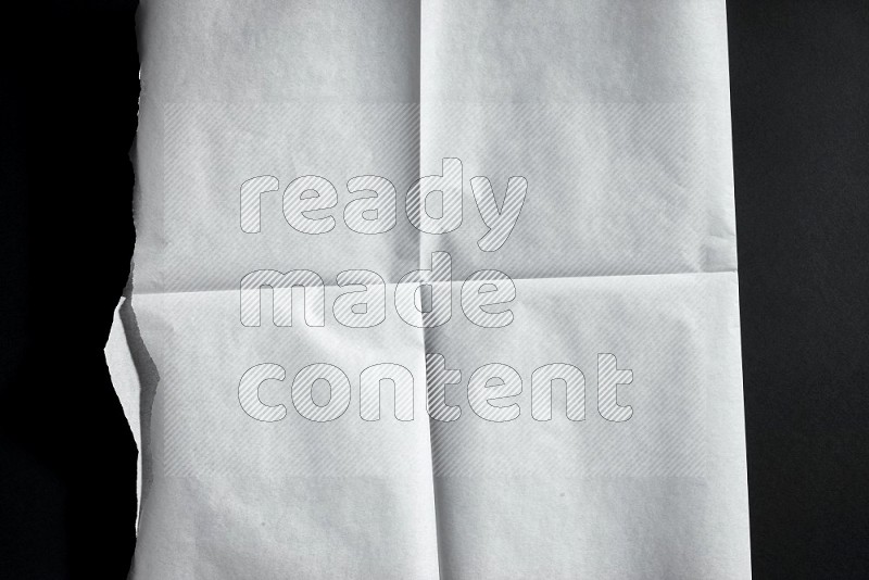 White paper sheet on black background