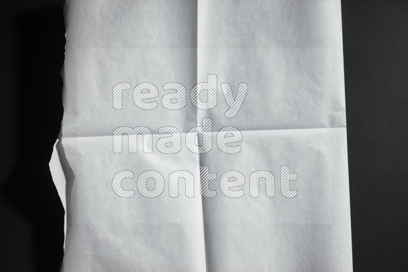 White paper sheet on black background