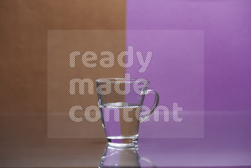 The image features a clear glassware filled with water, set against brown and purple background