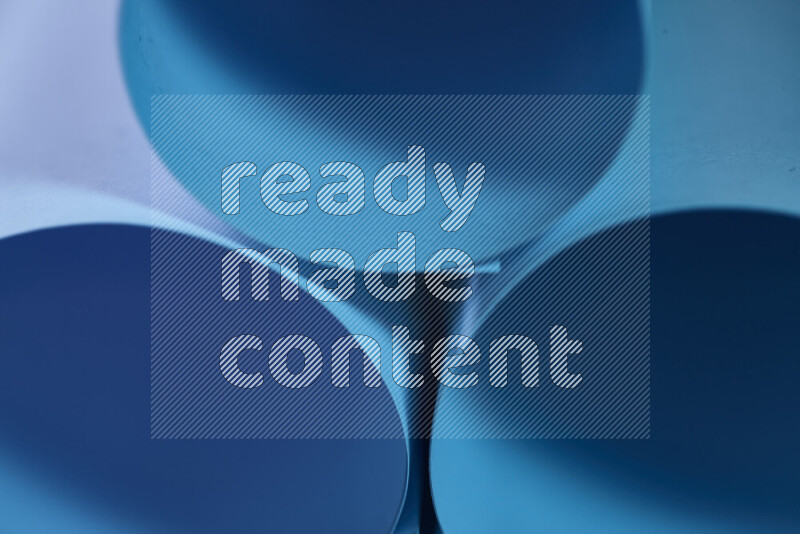 The image shows an abstract paper art with circular shapes in varying shades of blue