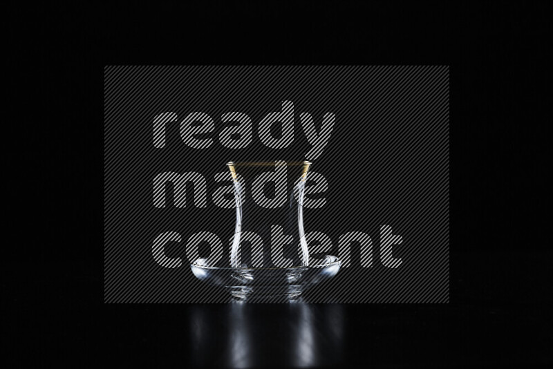 Glassware with rim light against black background