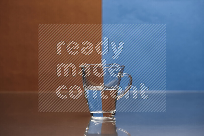 The image features a clear glassware filled with water, set against brown and blue background