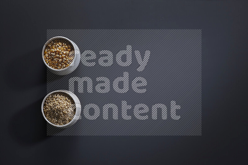 Legumes in pottery bowls on grey background