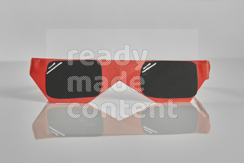 Origami sun glasses on grey background