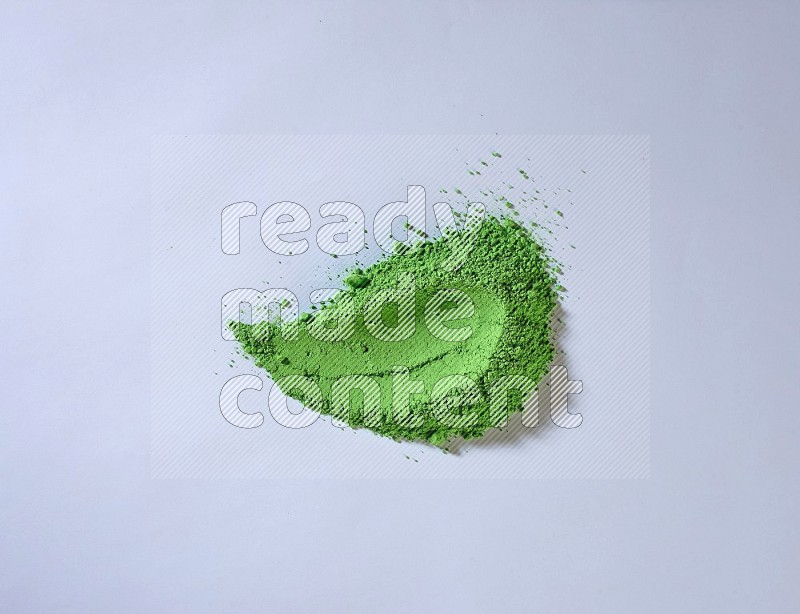 Green powder strokes on white background