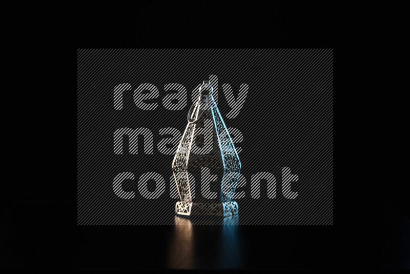 Ramadan lanterns with colored rim light against black background