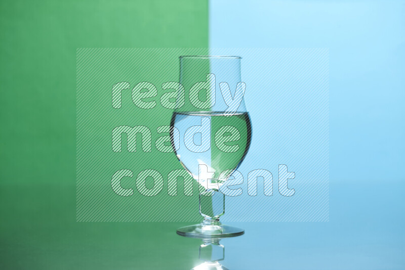 The image features a clear glassware filled with water, set against green and light blue background