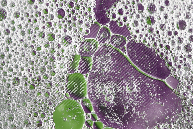 Close-ups of abstract soap bubbles and water droplets on green and purple background