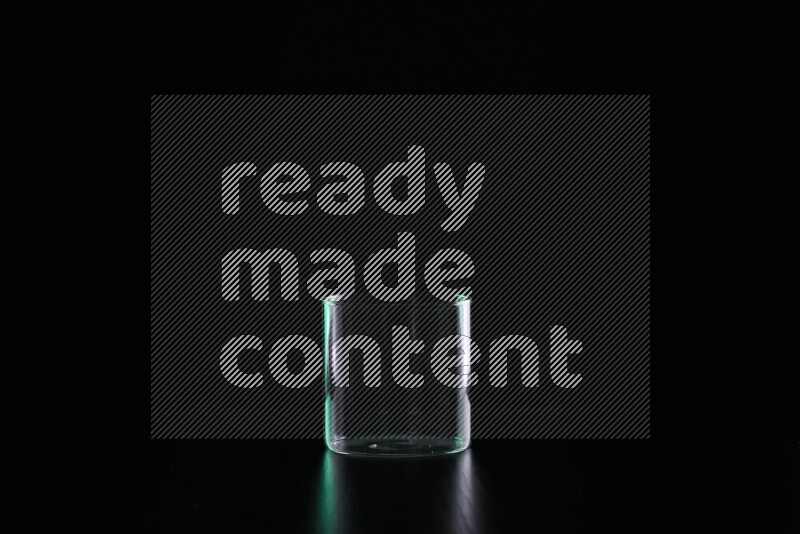 Glassware with rim light in green and white against black background