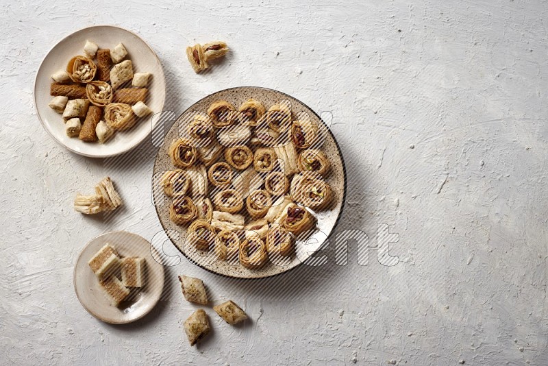 Oriental sweets in pottery plates in a light setup