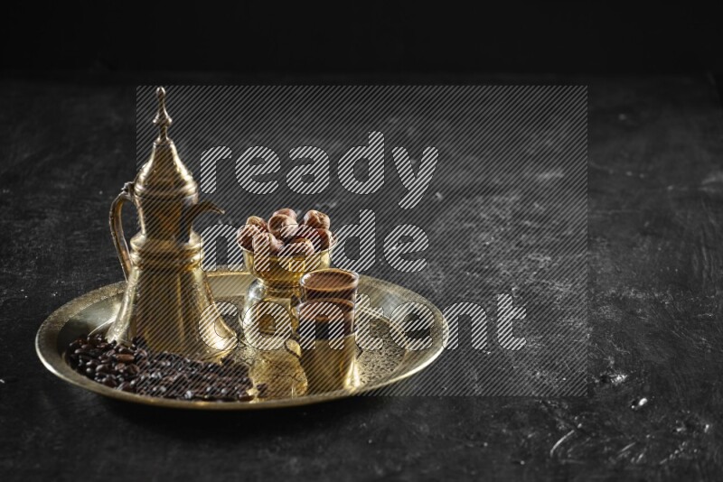 Dates with a drink on a metal tray in a dark setup