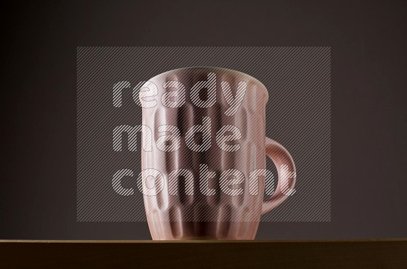 Low angle shot of a pink cup on grey background