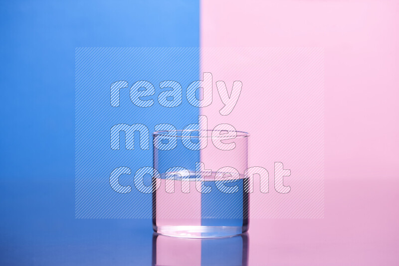 The image features a clear glassware filled with water, set against blue and rose background