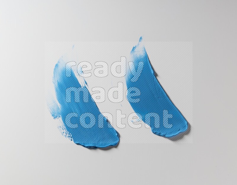 Blue curved painting knife strokes on white background