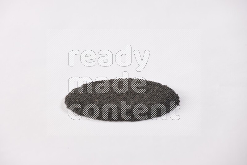 Black seeds in a circle shape on a white flooring