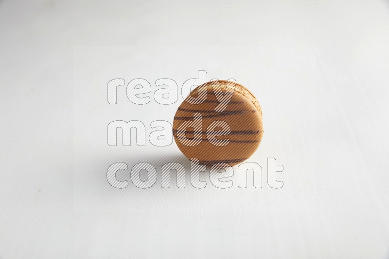 45º Shot of light brown  Almond Cream macaron on white background