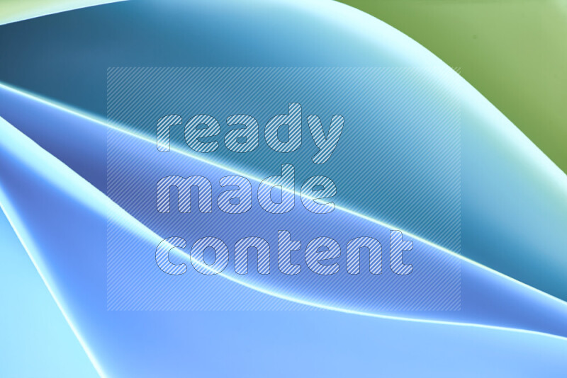 هذه الصورة تعرض تكوين فن الورق التجريدي مع منحنيات ورقية بتدرجات اللون الأخضر والأزرق المكونه بواسطة الضوء الملون