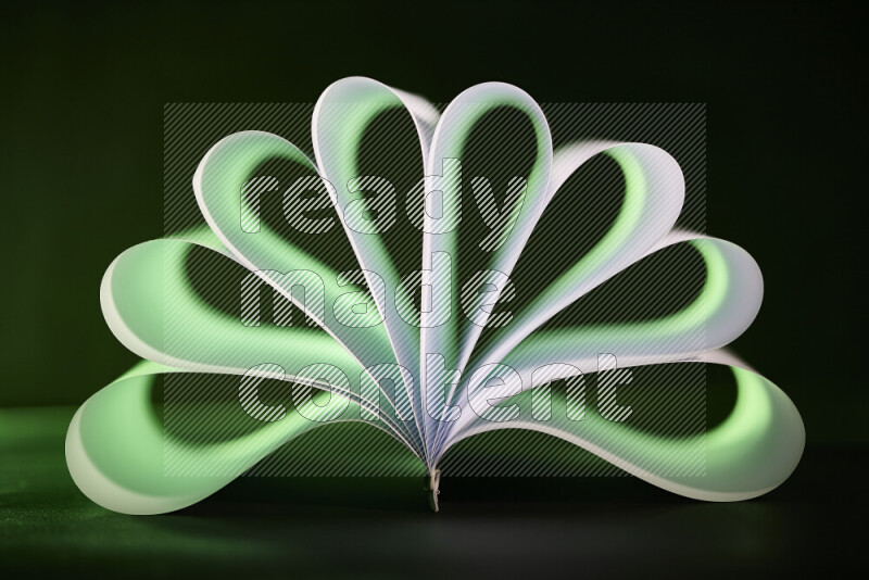 An abstract art piece displaying smooth curves in green and white gradients created by colored light