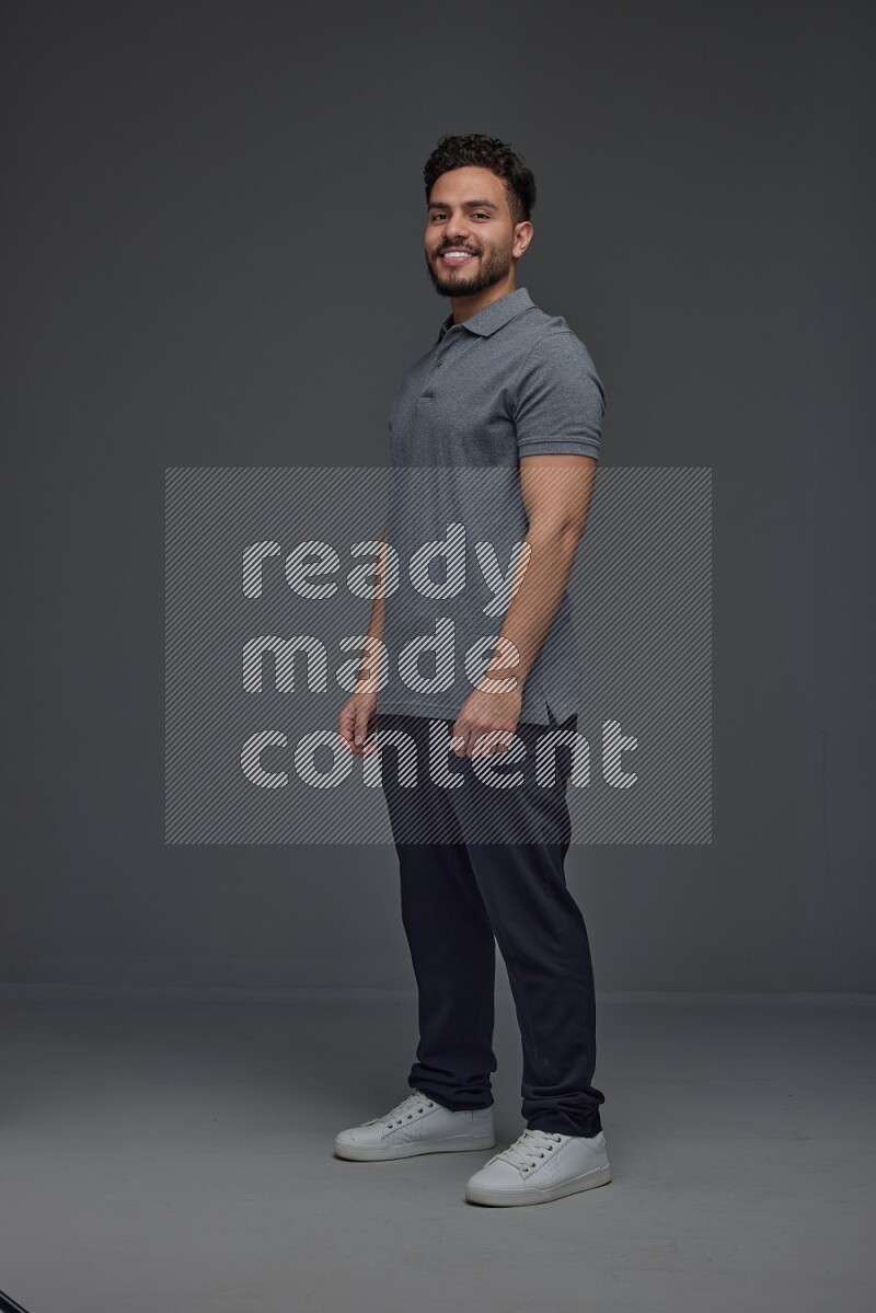 A man wearing casual making multi stand poses  eye level on a gray background