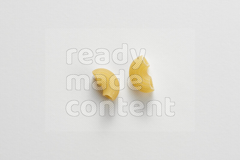Elbow pasta on white background
