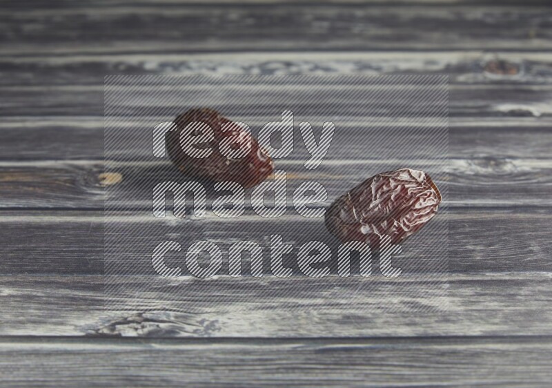 two madjoul dates on a wooden grey background