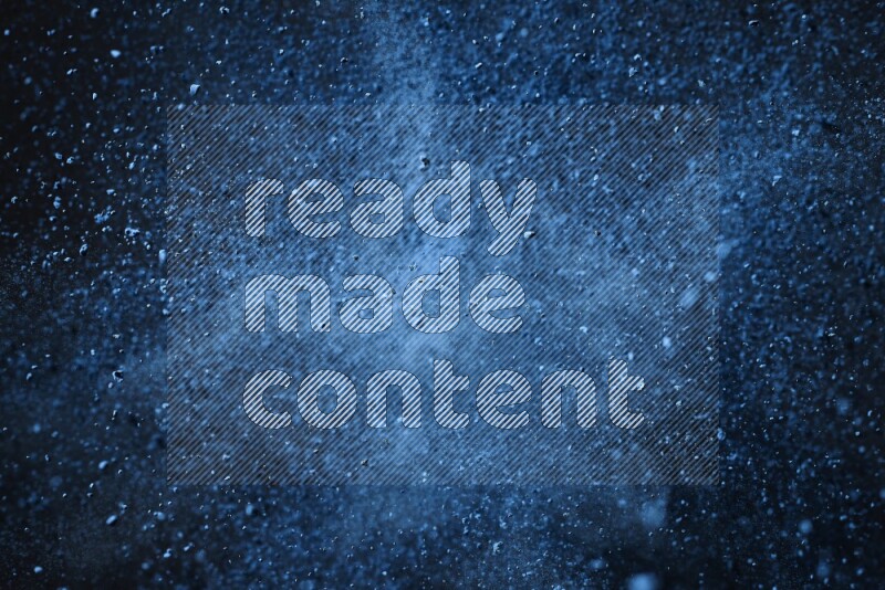 Blue powder explosion on black background