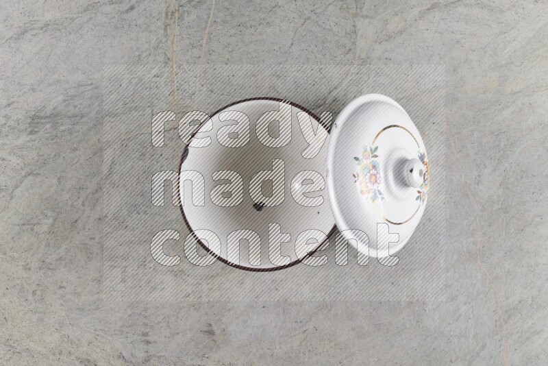 A vintage metal pot on grey marble background