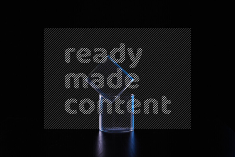 Glassware with rim light in blue and white against black background