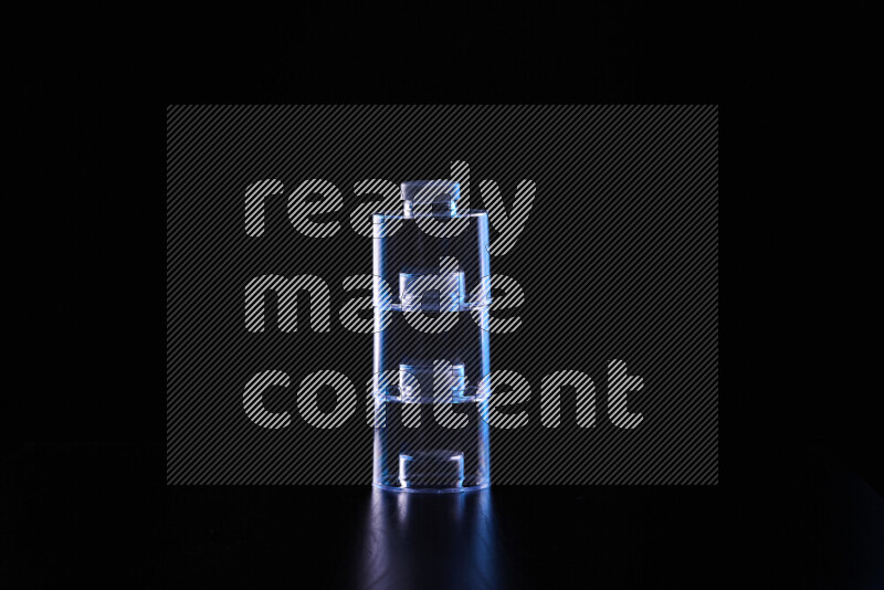 Glassware with rim light in blue and white against black background